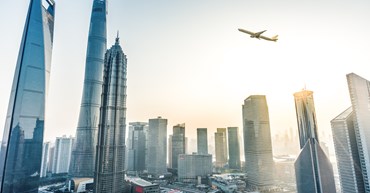 plane flies over shanghai